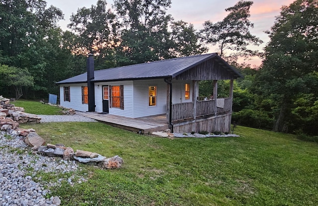 11498 Weatherman Dr, Mountain Grove, MO 65711 - back of property featuring metal roof, a yard, a chimney, and covered porch