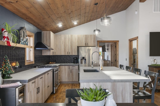 kitchen with stainless steel appliances, dark wood-style floors, wall chimney exhaust hood, and light brown cabinetry