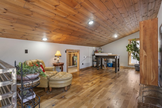 living area featuring lofted ceiling, wooden ceiling, baseboards, and wood finished floors