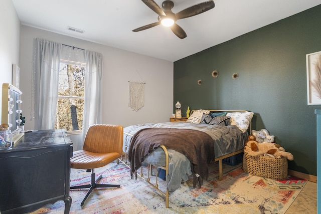 bedroom featuring a ceiling fan, visible vents, and baseboards