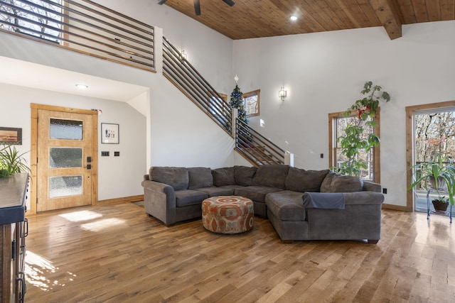 living area with wooden ceiling, stairway, beam ceiling, and wood finished floors