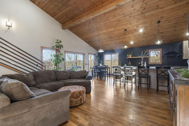 living room with stairway, wood ceiling, wood finished floors, high vaulted ceiling, and beamed ceiling