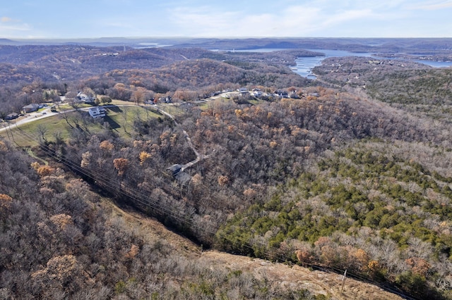 birds eye view of property featuring a view of trees