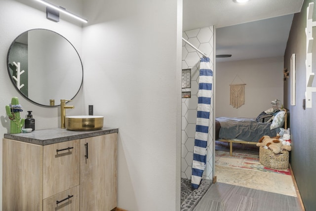 bathroom featuring curtained shower and vanity