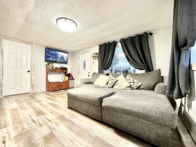 bedroom with light wood-type flooring and a textured ceiling