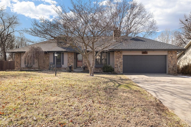 single story home featuring a front yard and a garage