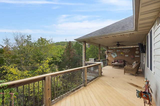 deck with an outdoor living space and a ceiling fan