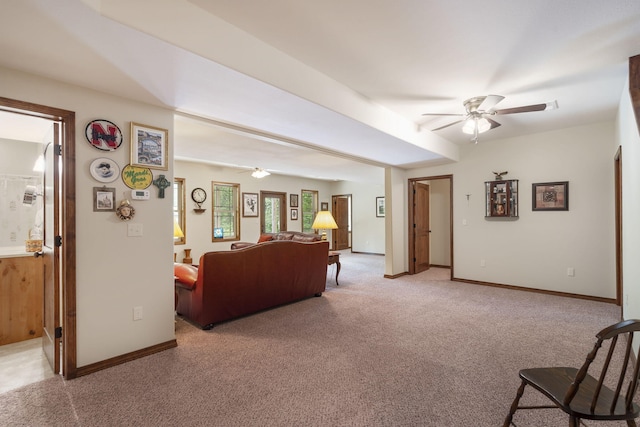 living room with carpet floors, a ceiling fan, and baseboards