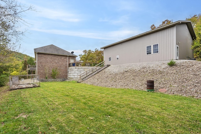 exterior space with stairway and a lawn