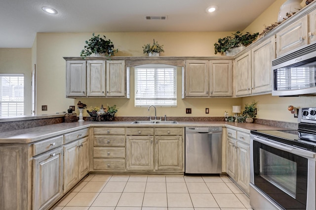 kitchen with sink, appliances with stainless steel finishes, and light tile patterned floors