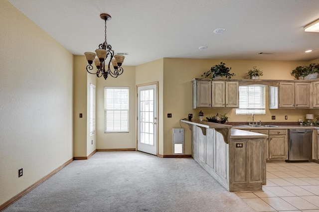 kitchen with hanging light fixtures, light colored carpet, sink, dishwasher, and light brown cabinets