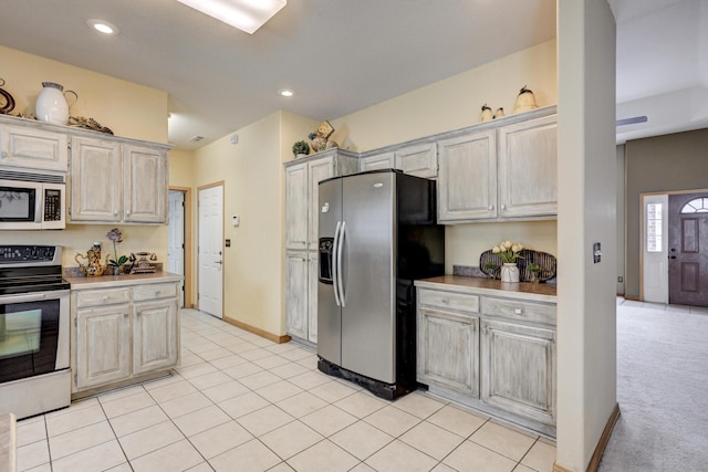 kitchen featuring stainless steel appliances and light tile patterned floors