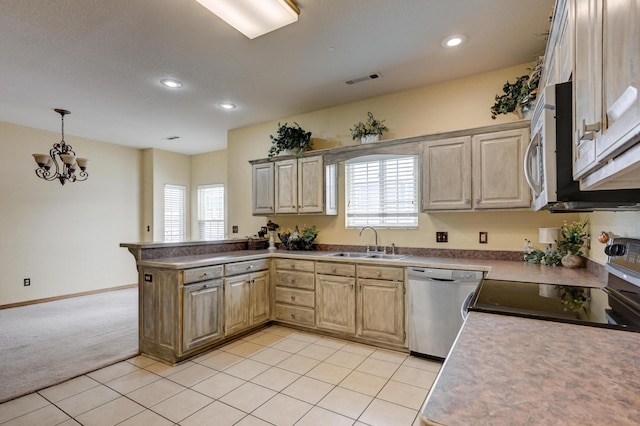 kitchen with plenty of natural light, sink, stainless steel appliances, and kitchen peninsula