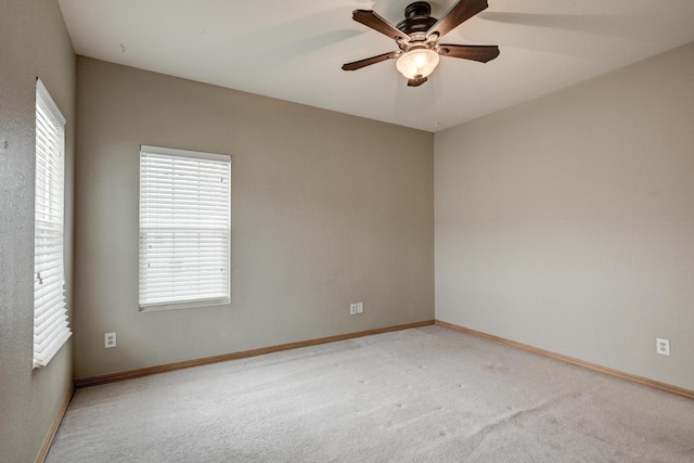 spare room featuring ceiling fan and carpet floors