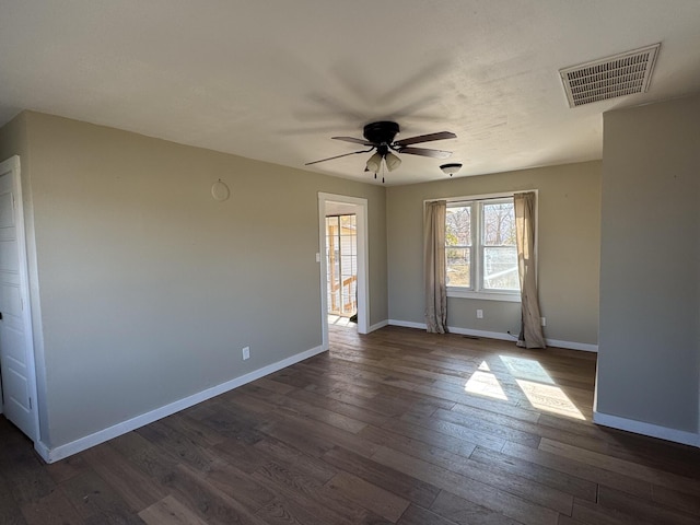 spare room featuring dark hardwood / wood-style floors and ceiling fan