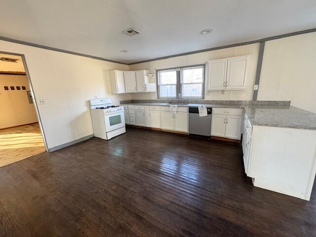 kitchen with dark hardwood / wood-style flooring, dishwasher, white gas stove, white cabinets, and crown molding