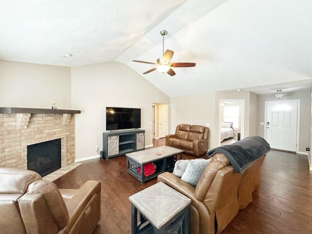 living room with a brick fireplace, lofted ceiling, ceiling fan, and dark hardwood / wood-style floors