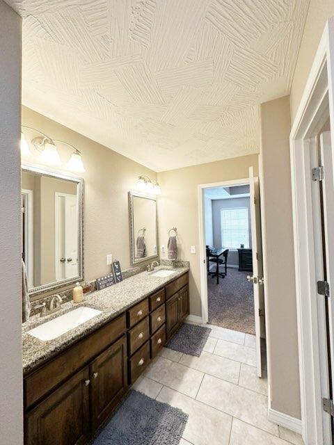 bathroom with tile patterned floors and vanity