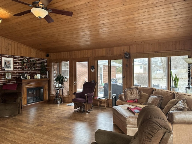 living room featuring hardwood / wood-style flooring, vaulted ceiling, wood walls, and wooden ceiling