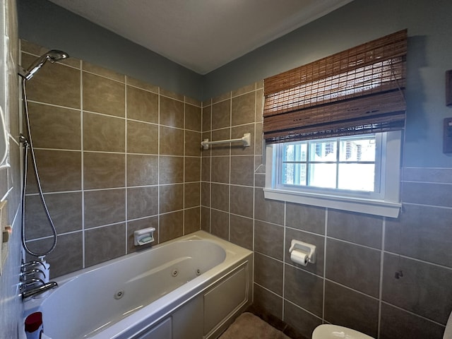bathroom with a combined bath / shower with jetted tub and tile walls