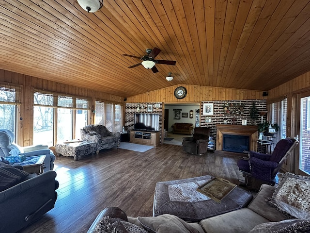 living room with a fireplace, wood-type flooring, vaulted ceiling, wooden walls, and wooden ceiling