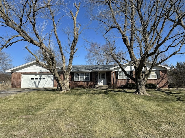 single story home with aphalt driveway, brick siding, a garage, and a front lawn