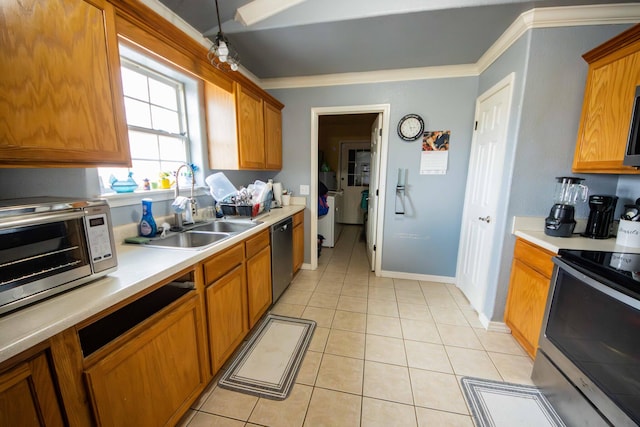 kitchen with sink, light tile patterned flooring, crown molding, and stainless steel appliances