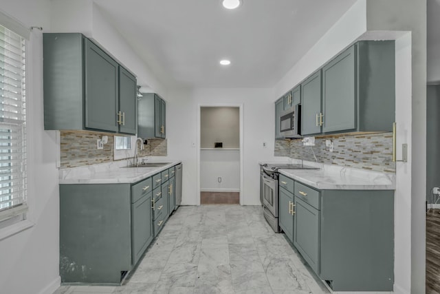 kitchen with sink, tasteful backsplash, stainless steel appliances, and light stone counters