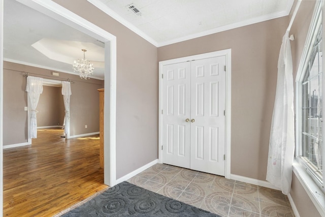 interior space featuring baseboards, visible vents, a chandelier, and crown molding