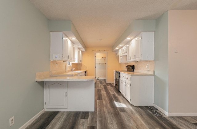 kitchen with sink, backsplash, dark wood-type flooring, black / electric stove, and white cabinets