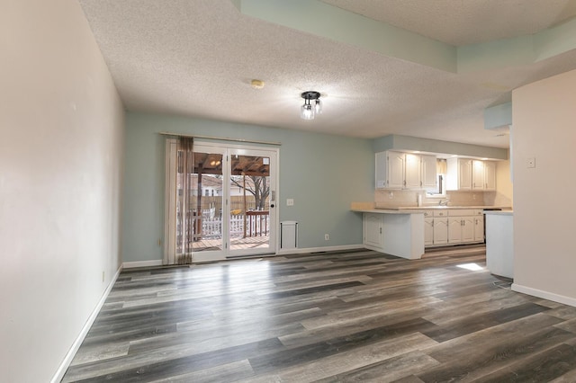 interior space with dark hardwood / wood-style flooring and a textured ceiling