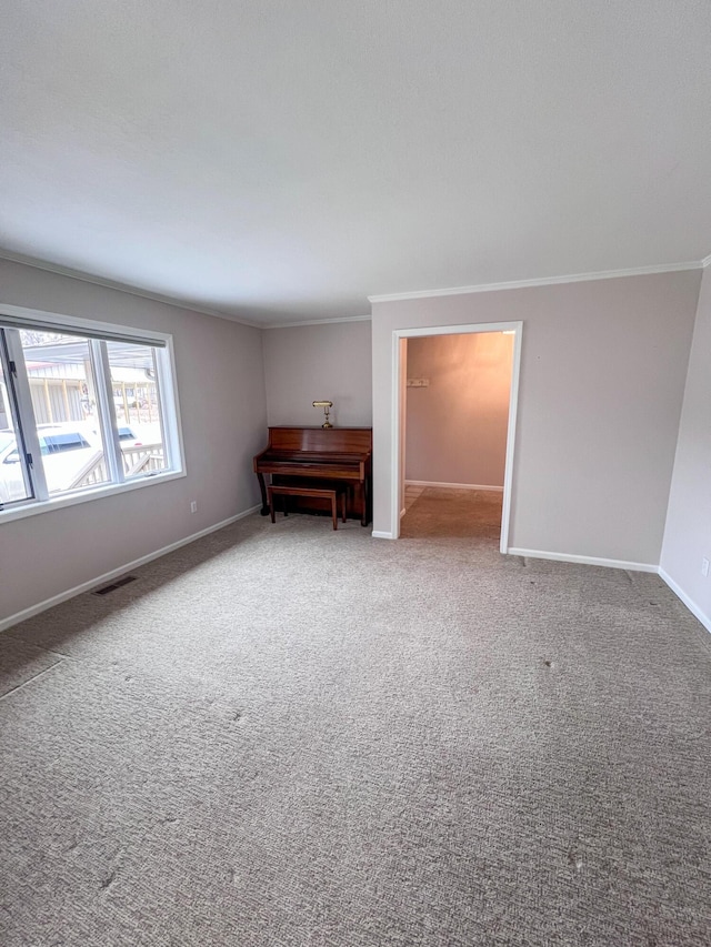 carpeted spare room featuring ornamental molding