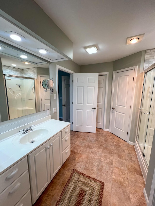 bathroom featuring vanity and a shower with shower door