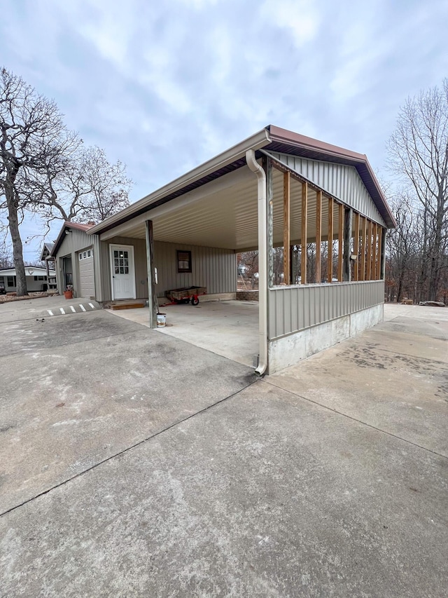 view of parking / parking lot featuring a carport and a garage