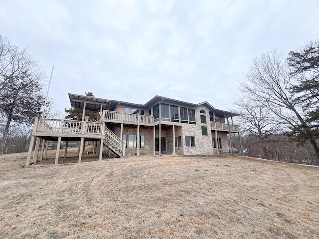 back of house featuring a deck and a yard