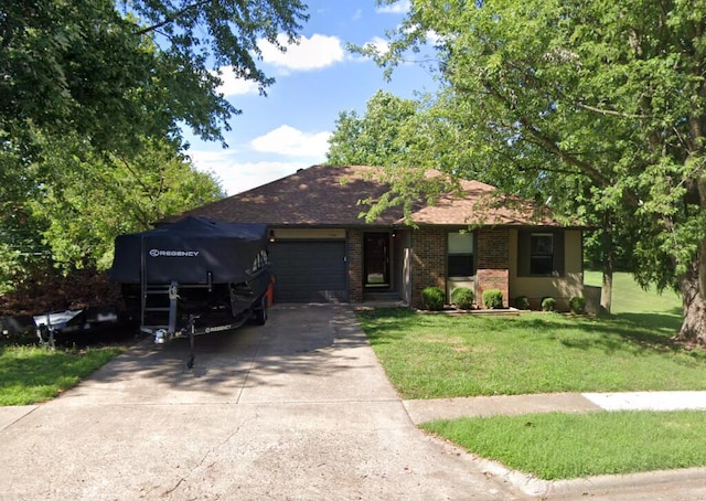 ranch-style home with a front yard and a garage