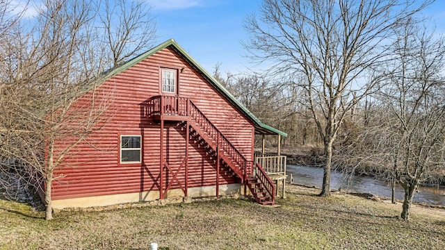 view of home's exterior featuring a yard and a water view