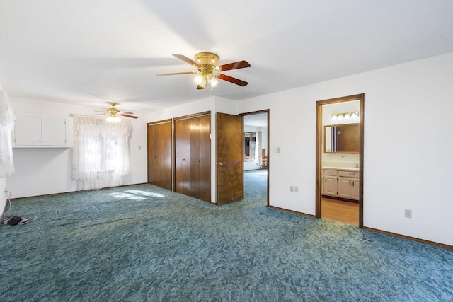 unfurnished bedroom with ceiling fan, light colored carpet, and ensuite bathroom