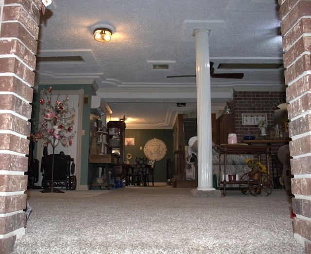 basement with ornamental molding, carpet, visible vents, and a textured ceiling