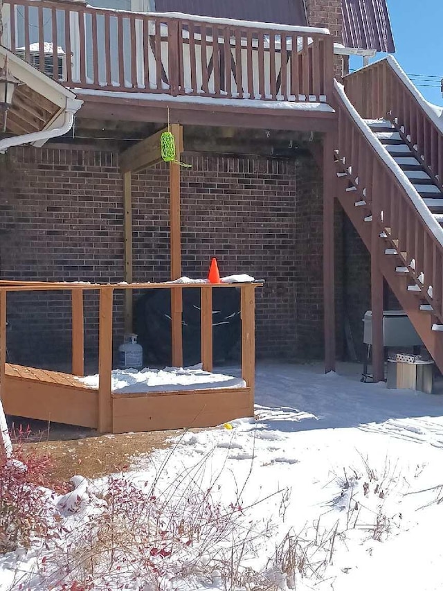 exterior space featuring stairs and brick siding