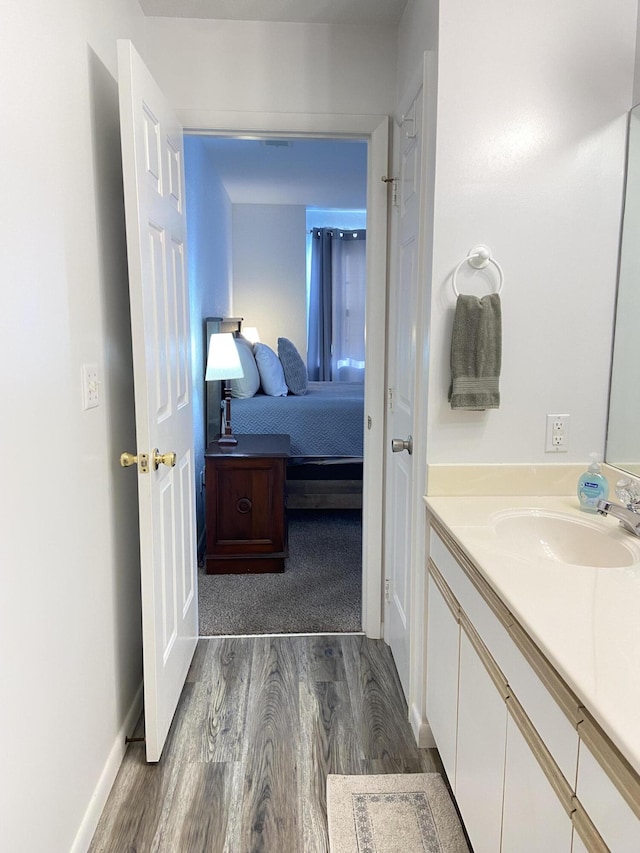 bathroom with hardwood / wood-style flooring and vanity