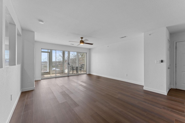 unfurnished living room with dark hardwood / wood-style flooring, ceiling fan, and a textured ceiling