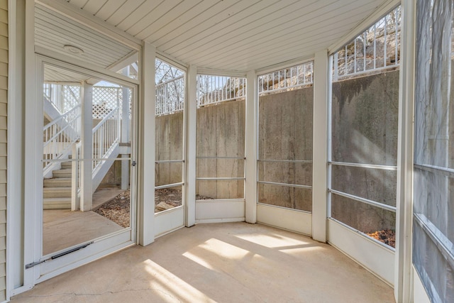 unfurnished sunroom with wooden ceiling