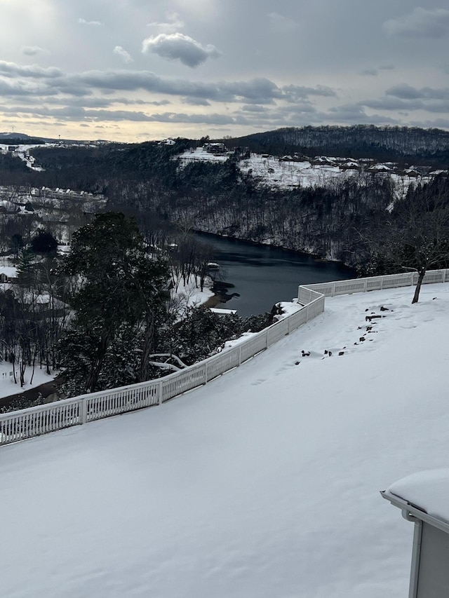 snowy aerial view featuring a water view