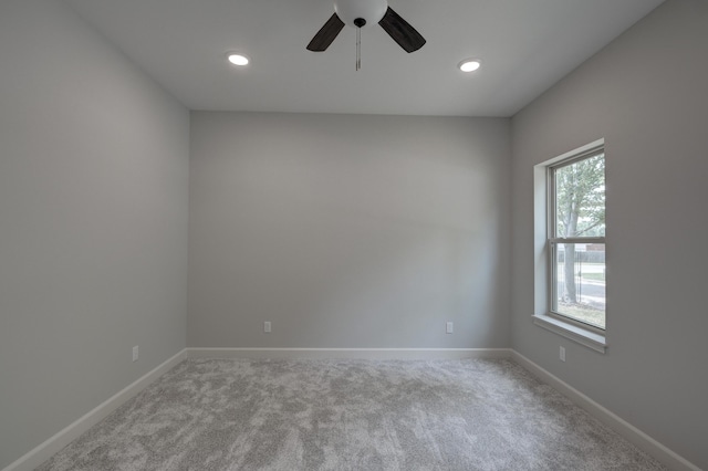 carpeted spare room with ceiling fan