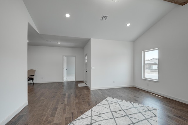 unfurnished living room featuring lofted ceiling and dark hardwood / wood-style floors