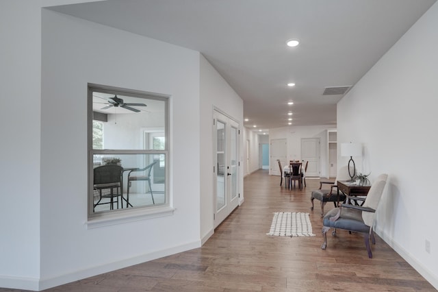 hall with hardwood / wood-style flooring