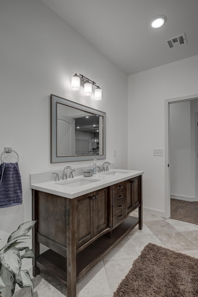 bathroom featuring tile patterned flooring and vanity