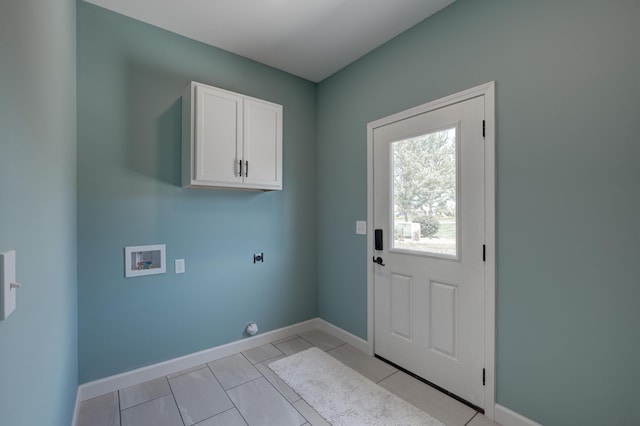 washroom featuring hookup for a washing machine, light tile patterned floors, cabinets, and hookup for an electric dryer