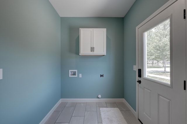 clothes washing area featuring cabinets, hookup for a washing machine, light tile patterned flooring, and electric dryer hookup